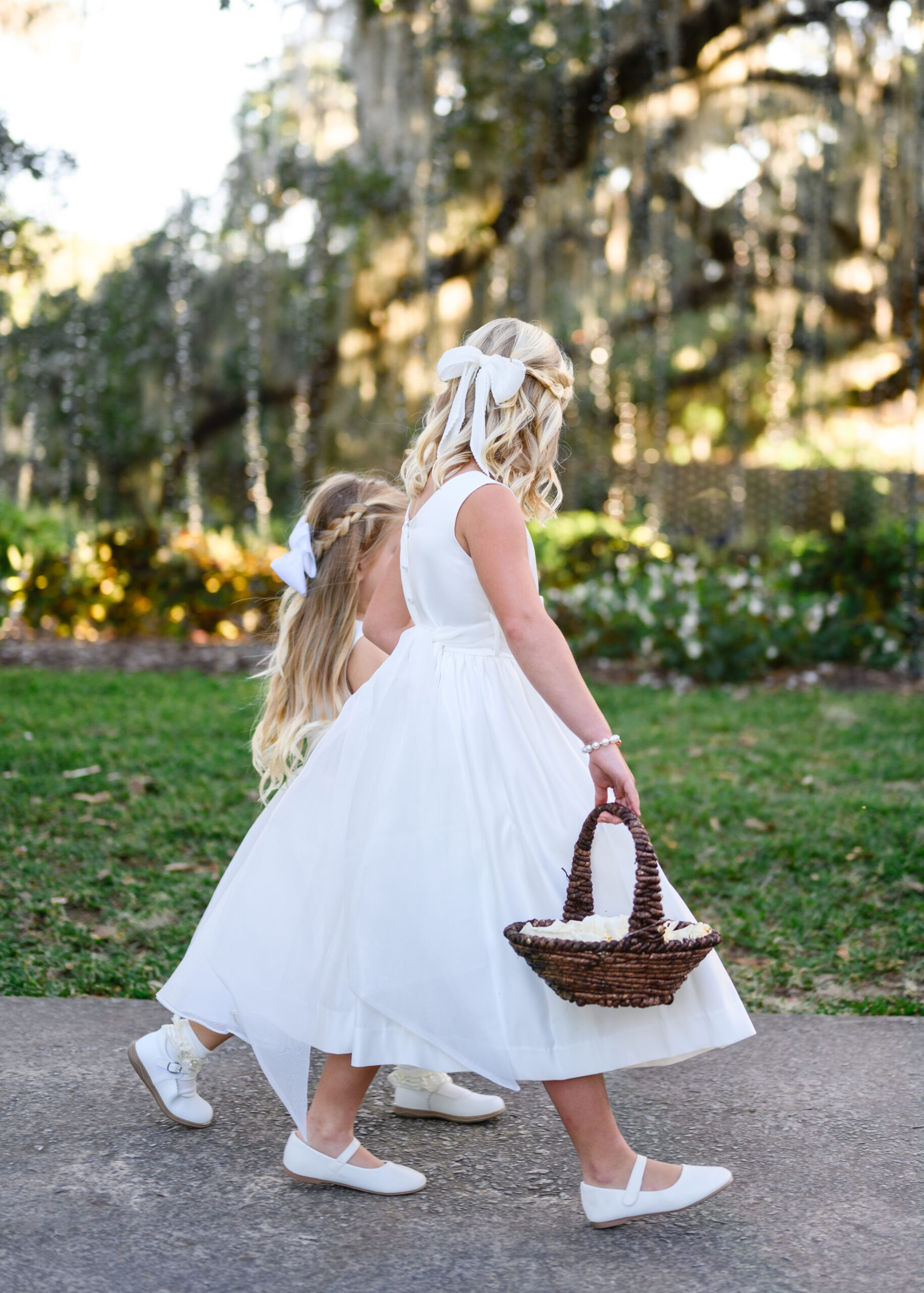 Flower girls walking the aisle at a Brookgreen Gardens wedding, Murrells Inlet SC