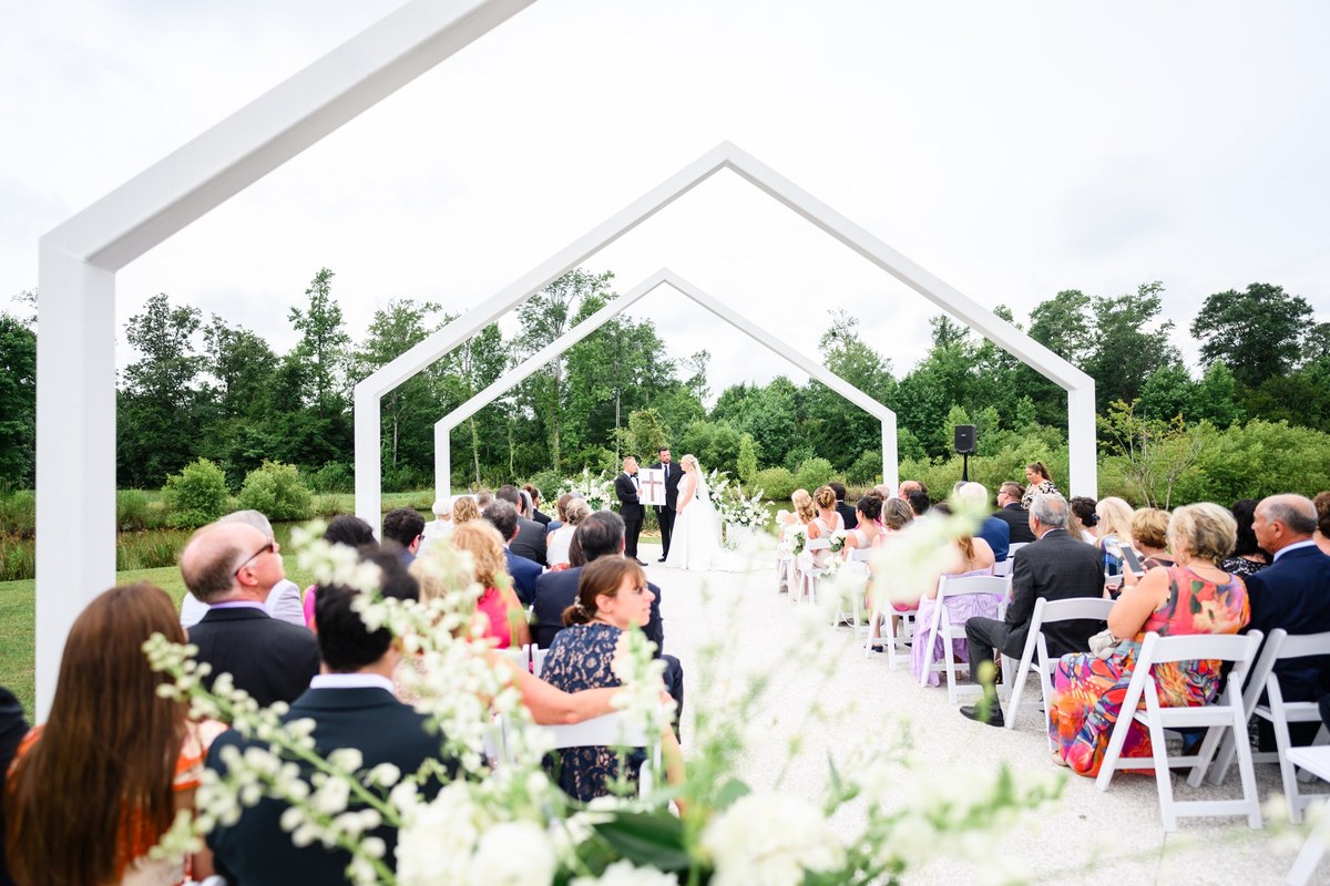 Ceremony through white arches at White Oaks, Myrtle Beach wedding photography