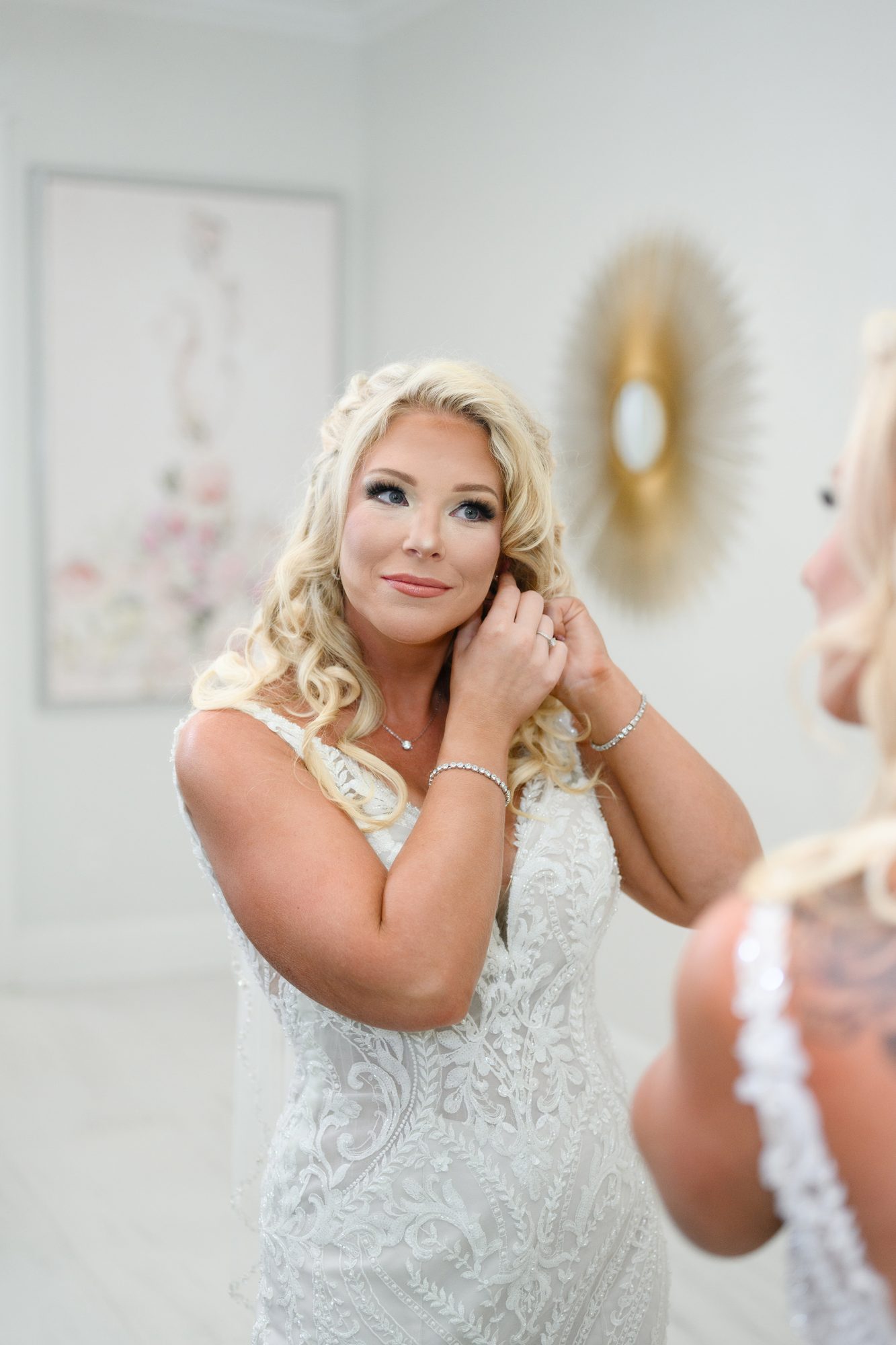 Olivia putting on her earrings in the bridal suite at 21 Main Events at North Beach