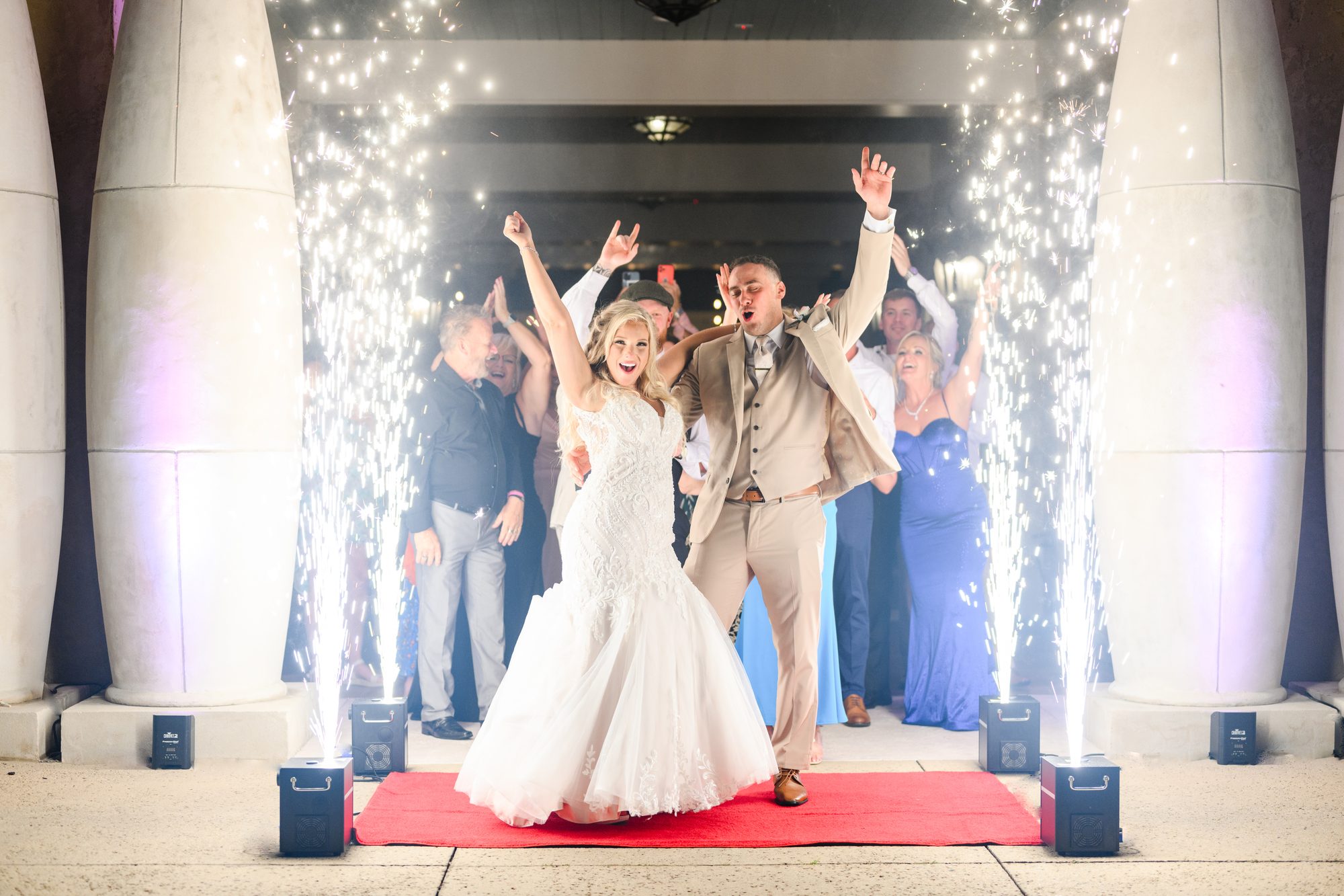 Olivia and Robert entering the reception between spark fountains at 21 Main