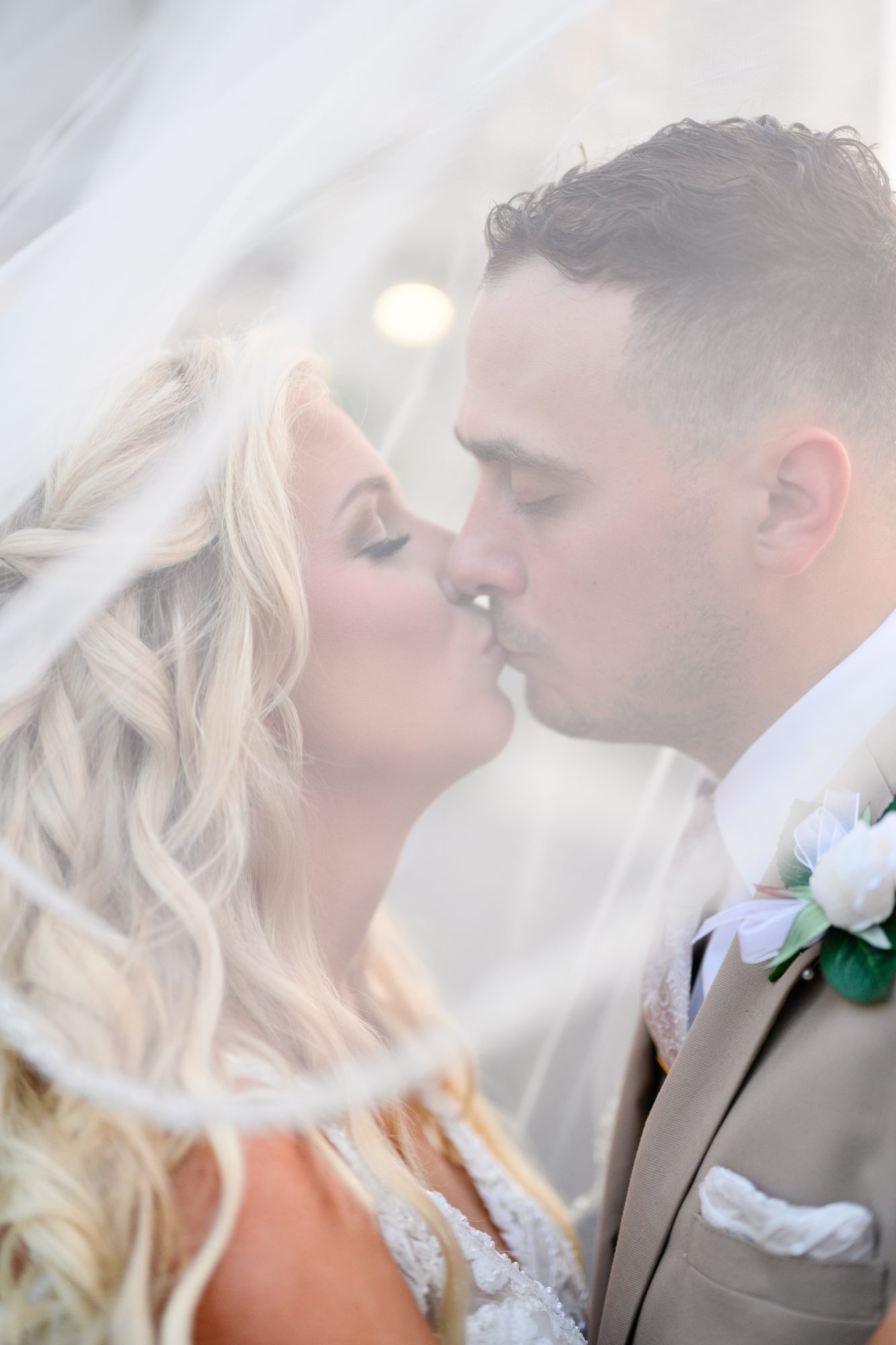 Olivia and Robert kissing under her veil at 21 Main Events in North Myrtle Beach