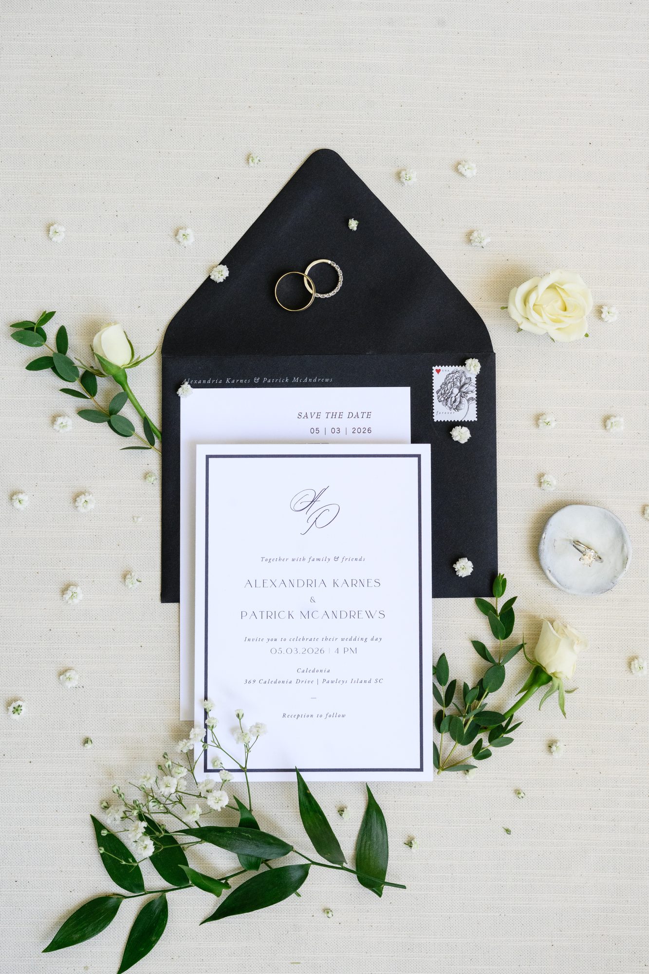 Ally and Patrick's black and white invitation suite with gold rings for their May 3, 2026 Caledonia wedding
