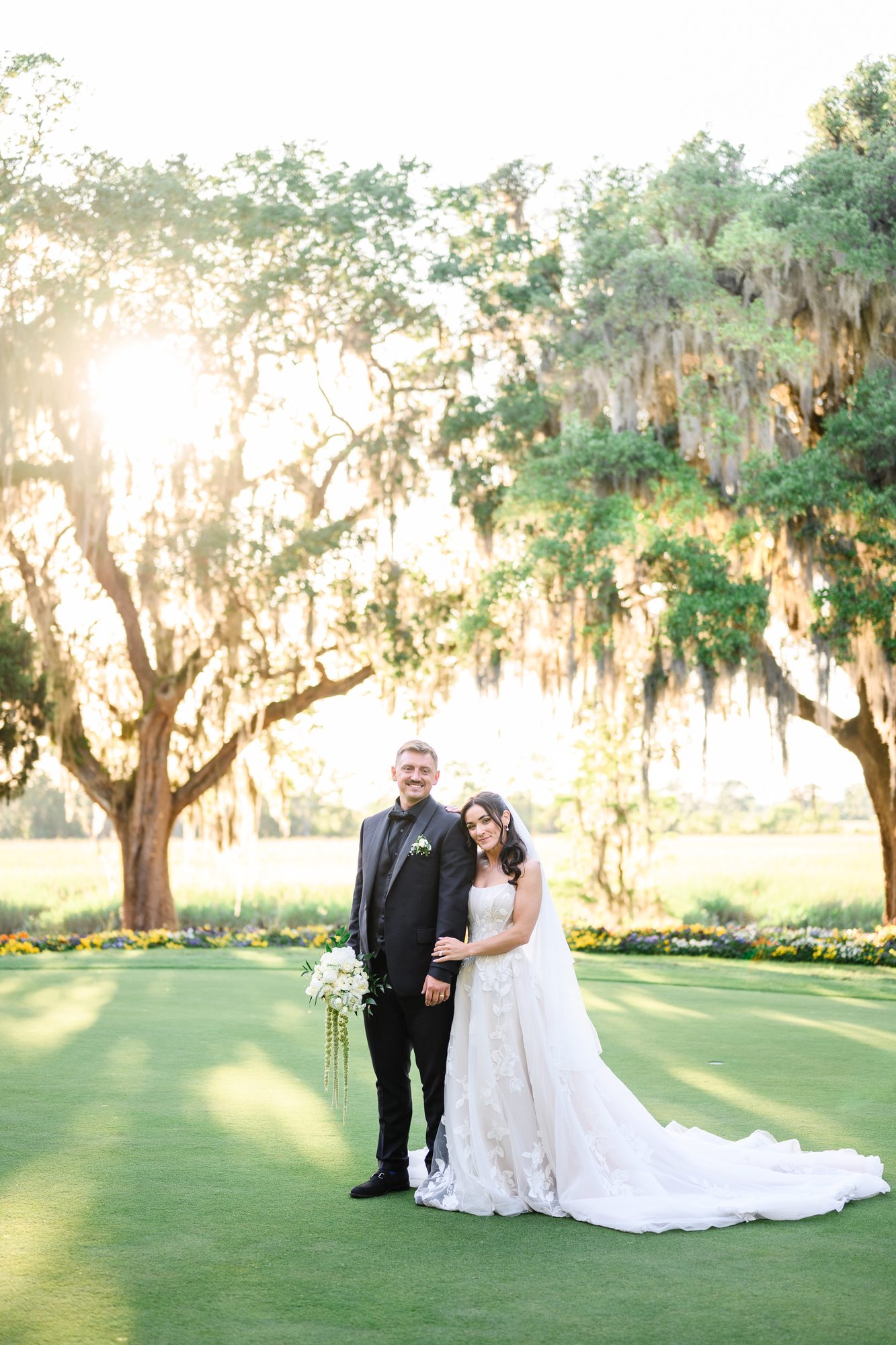 Ally and Patrick at sunset beneath live oaks on the lawn at Caledonia