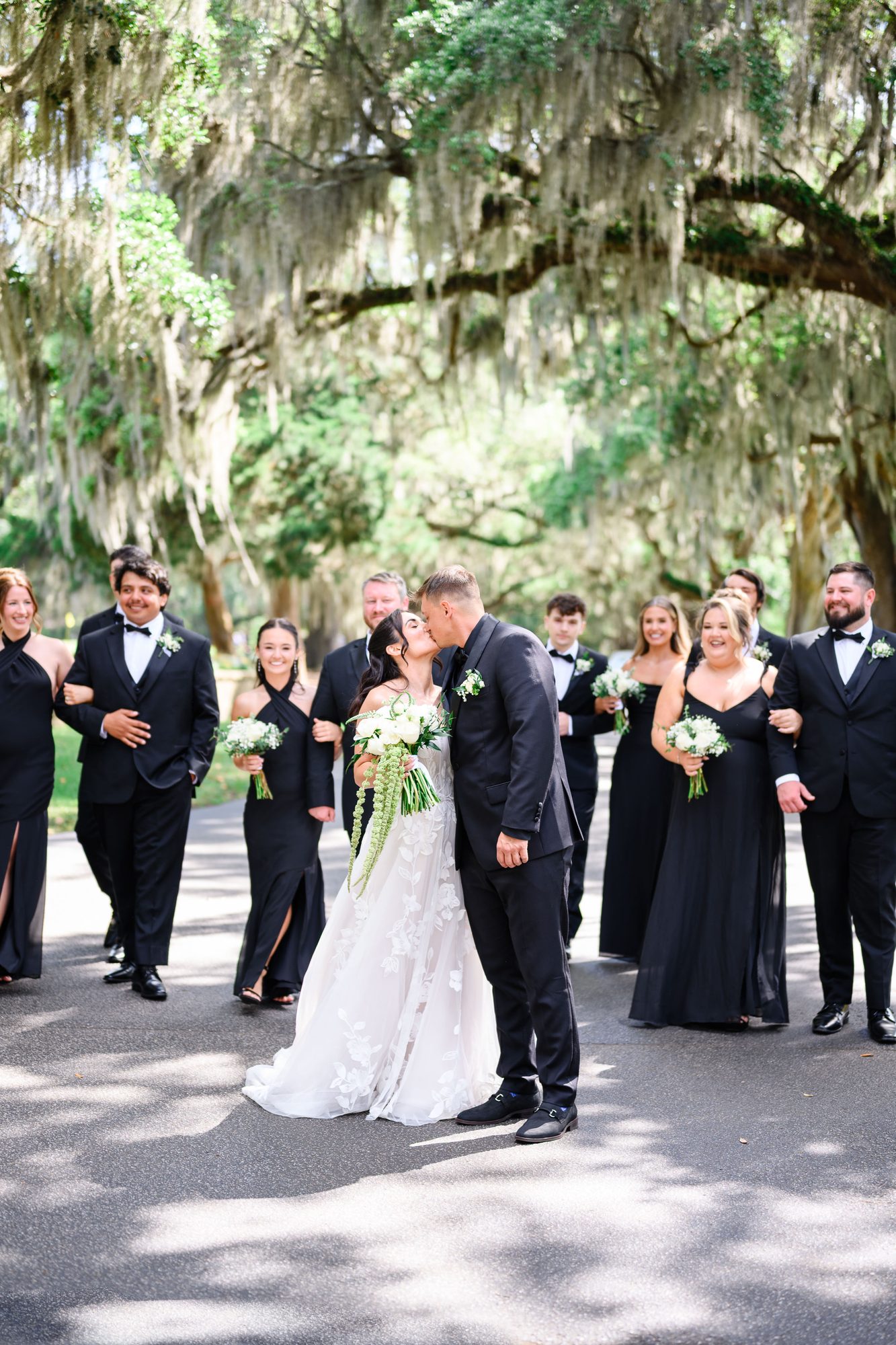 Ally and Patrick with their wedding party beneath Spanish moss at Caledonia Golf & Fish Club