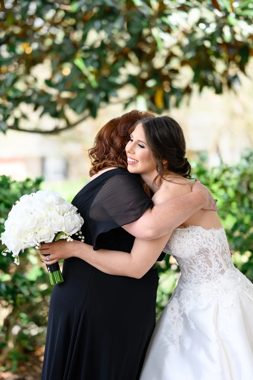 Kayla hugging her mother in the Pine Lakes garden before the ceremony
