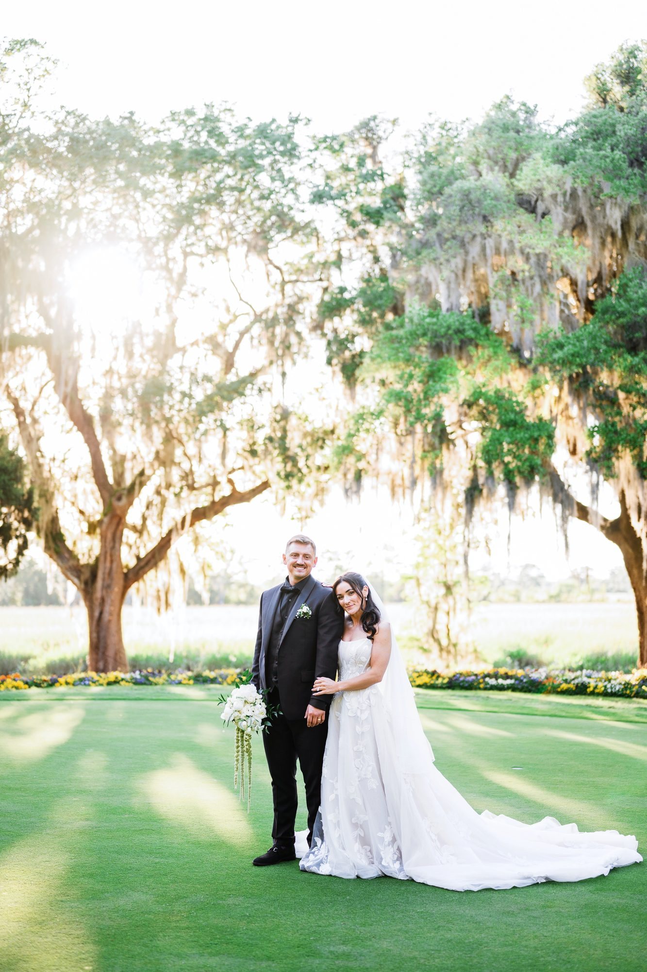 Bride and groom beneath Spanish moss oaks at golden hour, Myrtle Beach wedding