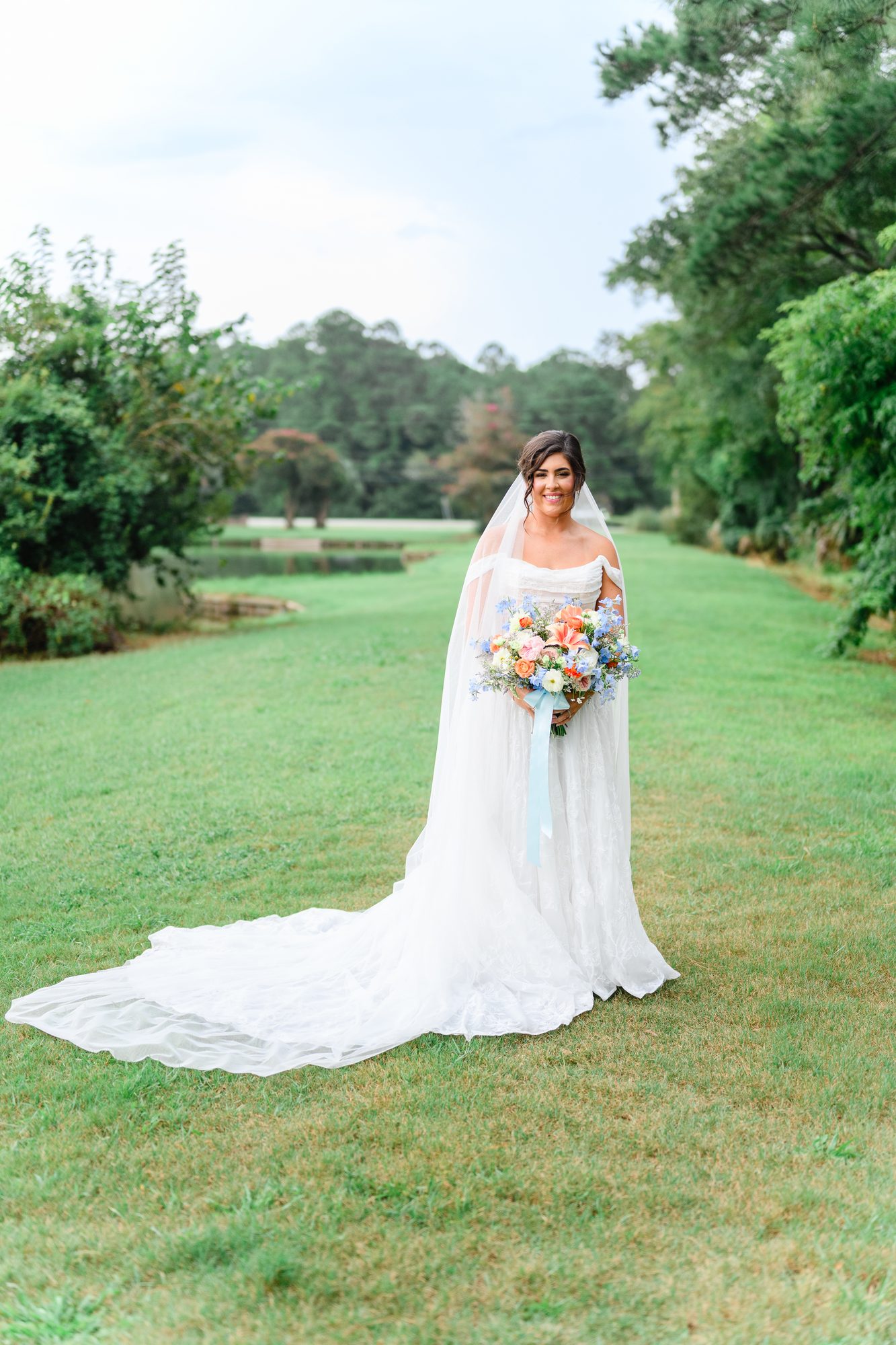 Elesabeth with her long train spread across the lawn at The Village House