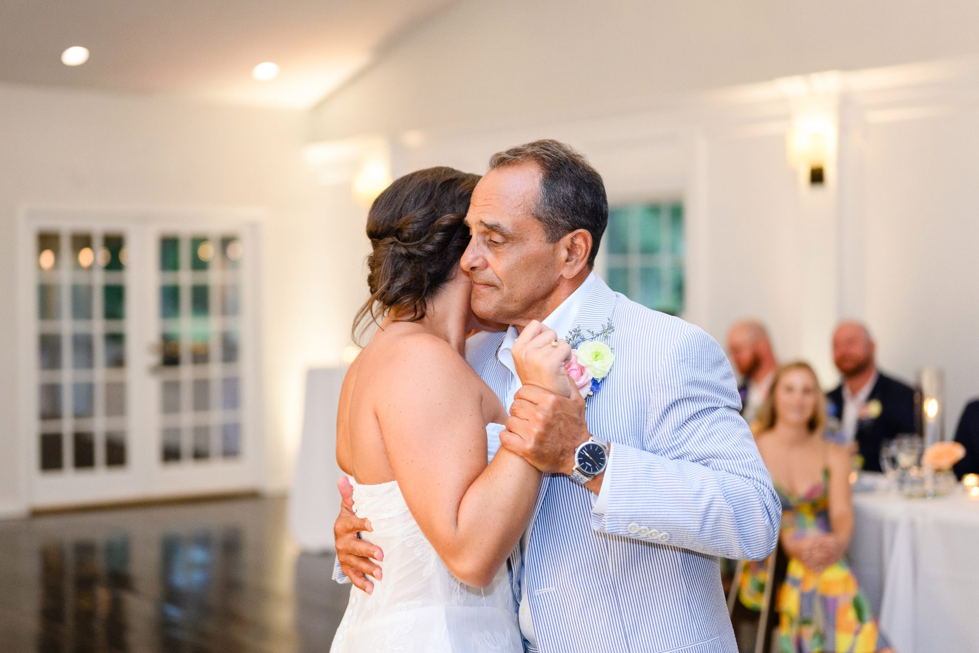 Elesabeth dancing with her father in a light blue suit at The Village House